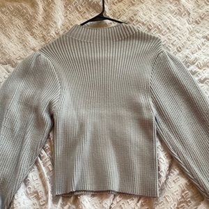 Truth, medium, light blue sweater